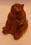 Black Forest-style carved wooden model of a seated bear,