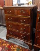 Small mahogany chest of two short and three long graduated drawers, on bracket feet,