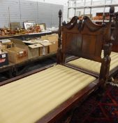 Mahogany framed single bed with carved swan neck headboard, on turned tapering legs,