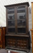 Glazed bookcase with pair of panel doors doors enclosing shelves,