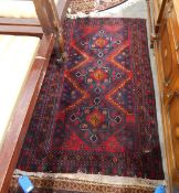 Handmade Eastern wool rug with dark blue ground, red zig-zag central field, geometric design,