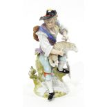 Continental porcelain figure of a man seated on a tree stump shearing sheep,