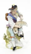 Continental porcelain figure of a man seated on a tree stump shearing sheep,