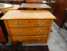 Modern hardwood chest of three long drawers, on bracket feet,