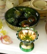 Green carnival glass punch set comprising a circular bowl decorated with fruiting vines,