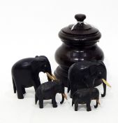 Set of carved ebony elephants and a turned wooden baluster-shaped lidded pot