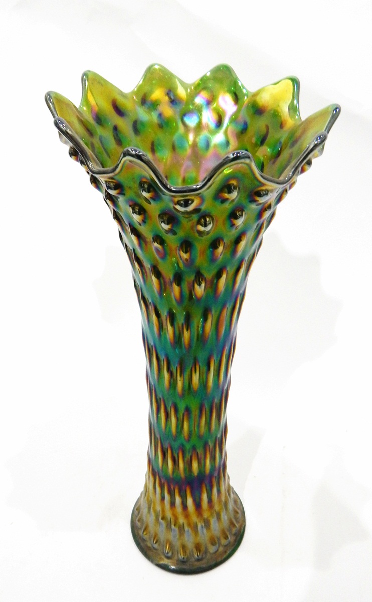 Large green carnival glass vase of flared dimpled design,
