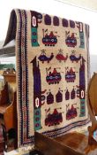 Handmade Eastern wool rug with beige ground, geometric military motifs including tanks, helicopters,