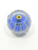 Glass paperweight by John Deacons of circular form with an outer layer of yellow,