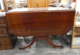 Mahogany fall-flap dining table supported on shaped standards,