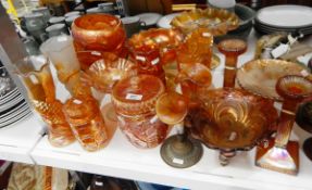 Quantity of carnival glass including vases, lidded jars, two posy vases, candlesticks, comports,