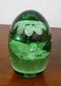 Victorian green glass dump paperweight with internal vase of flowers,