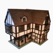 Tudor-style large doll's house, modelled on a Ledbury town house, fixed onto a table,