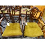 Two mahogany Hepplewhite-style shield-back open armchairs with pierced splats, upholstered seats,