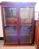 Dwarf display cabinet/bookcase, enclosed by two glass panel doors,