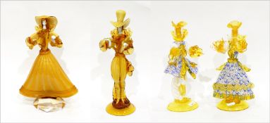 Pair of Murano glass figures of a gentleman and lady in elaborate yellow costumes,