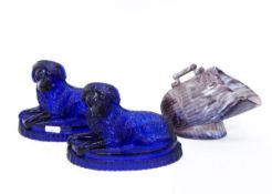 Pair of Victorian blue pressed glass dog ornaments, each recumbent dog on oval base,