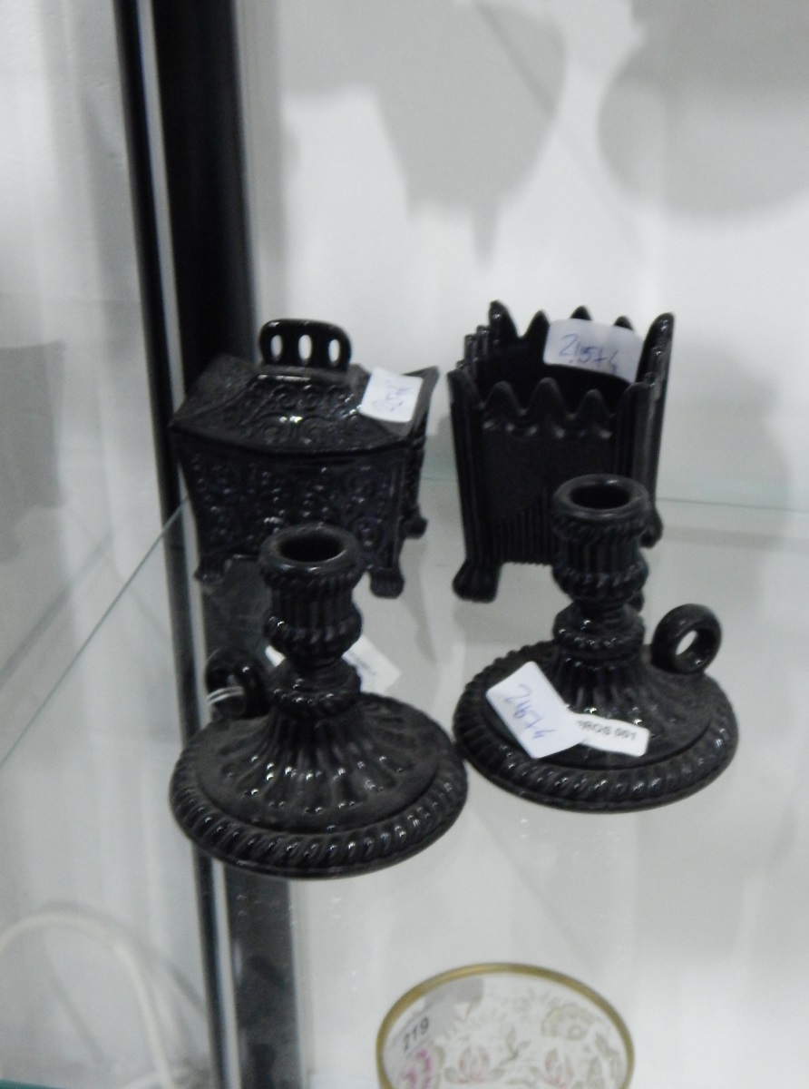 Pair of Victorian opaque black pressed glass candlesticks of knopped form with fluted decoration,