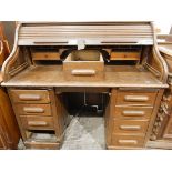 20th century oak piano-shaped roll-top desk, the interior fitted with small drawers,