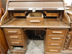 20th century oak piano-shaped roll-top desk, the interior fitted with small drawers,