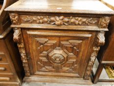 Victorian carved oak side cupboard, the frieze drawer with foliate carving,