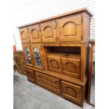 A modern oak cabinet comprising cupboards, mirror panel cupboards,