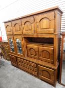 A modern oak cabinet comprising cupboards, mirror panel cupboards,