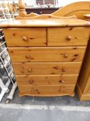 Pine chest, of two short and four long drawers, each with turned handles on bun feet,