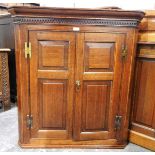 George III oak corner cupboard with dentil frieze,