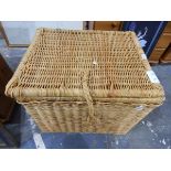 Large wickerwork laundry basket and a framed print of the Mona Lisa