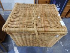 Large wickerwork laundry basket and a framed print of the Mona Lisa