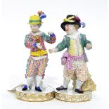 Pair of 19th century Meissen porcelain figures of boys dressed in elaborate costume (both af)