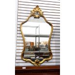 An 18th century style giltwood wall mirror with shell and C-scroll ornament surmount with wavy edge