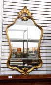 An 18th century style giltwood wall mirror with shell and C-scroll ornament surmount with wavy edge