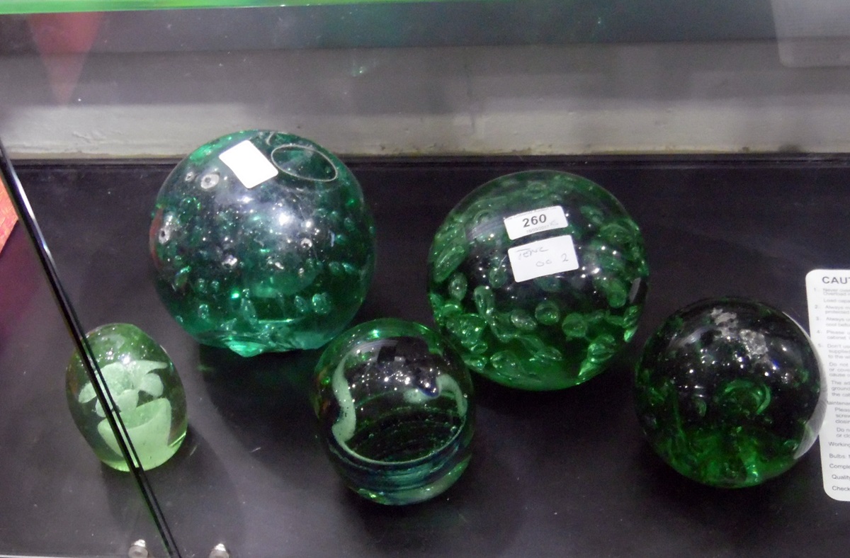 Green glass dump doorstop of spherical form with internal bubble decoration, 14cm high,