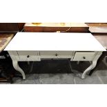 White dressing table with an arrangement of three drawers and on cabriole shaped supports,