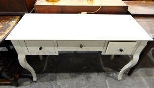 White dressing table with an arrangement of three drawers and on cabriole shaped supports,