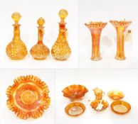 Pair of marigold carnival glass decanters decorated with the 'Imperial Grape' pattern, 32cm high,