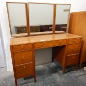 20th century teak bedroom suite by Maple viz:- a mirror-back dressing table with an arrangement of