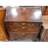 Georgian oak bureau, the fall-front enclosing a fitted interior of small drawers and pigeonholes,