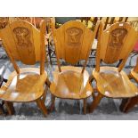 Set of four oak high back dining chairs with solid seats, the backs carved with a rampant lion,