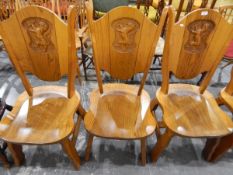 Set of four oak high back dining chairs with solid seats, the backs carved with a rampant lion,