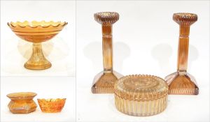 Marigold carnival glass pedestal bowl decorated with roses,