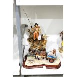 Tinted bisque figural scene of fisherman,