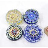 Four glass paperweights,