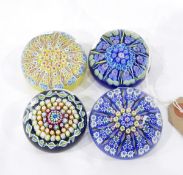 Four glass paperweights,