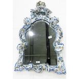 Meissen style porcelain wall mirror in the shape of a shield, with floral and scroll decoration,