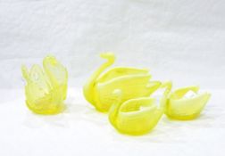 Three Victorian uranium pressed glass models of swans by Burtles Tate & Co and a similar wall