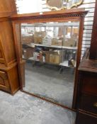 A late 19th century walnut framed wall mirror with dentil cornice,