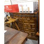A modern panelled oak bowfront bar with metal rail, and a pair of bar stools,
